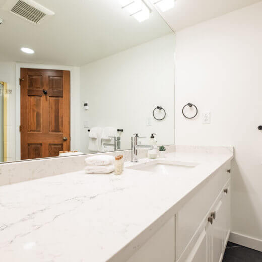 Spacious bathroom vanity with a large mirror and sink.